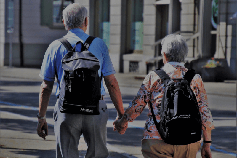 Senior man and women walking holding hands