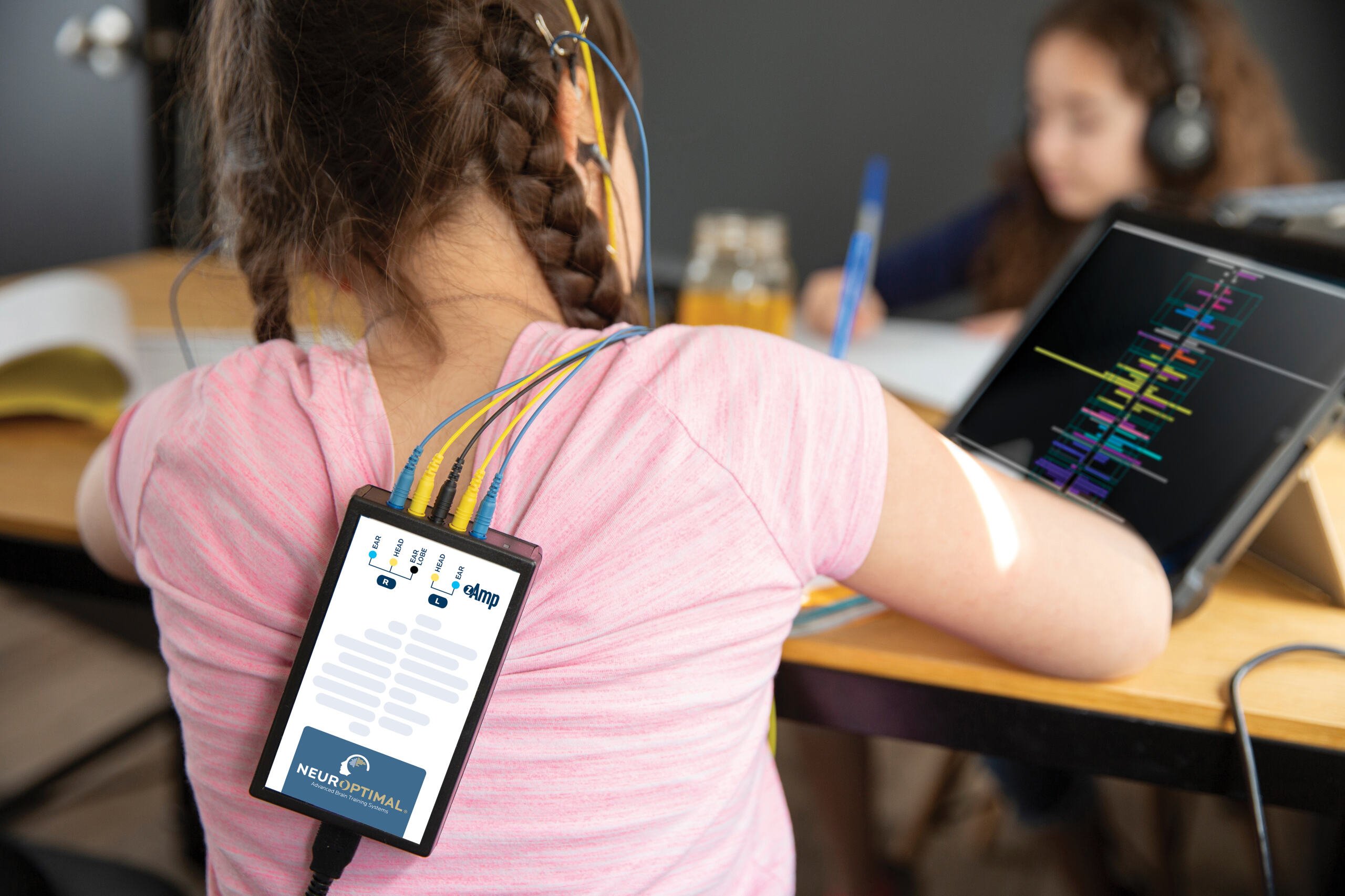 young girl using NeurOptimal while doing homework