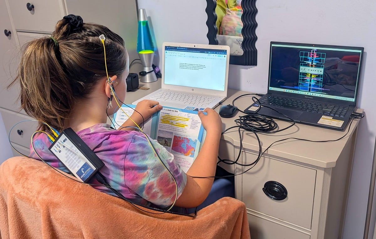 Young girl with NeurOptimal tablet running a session on couch