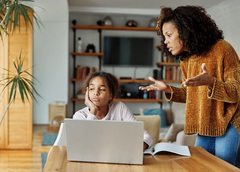 Child refuses to do homework and sits frustrated at the table