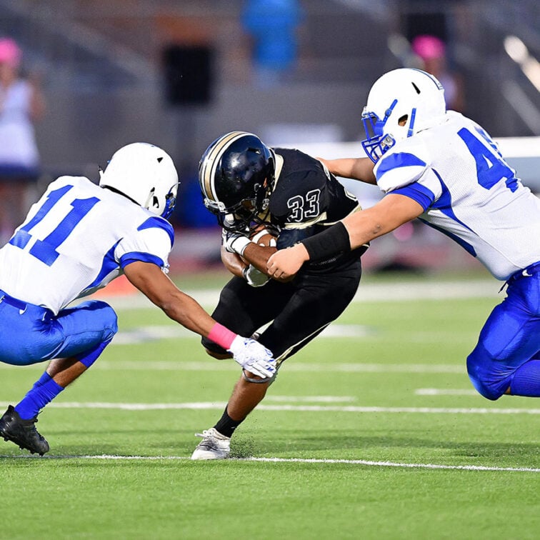 Football player making a tackle during a game